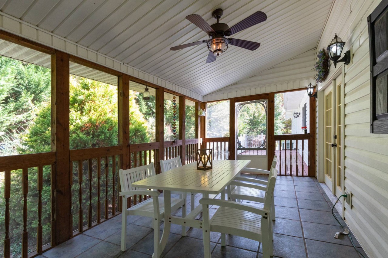 An enclosed patio with a table and chairs at Benchmark Shutters & Shades near Apex, NC