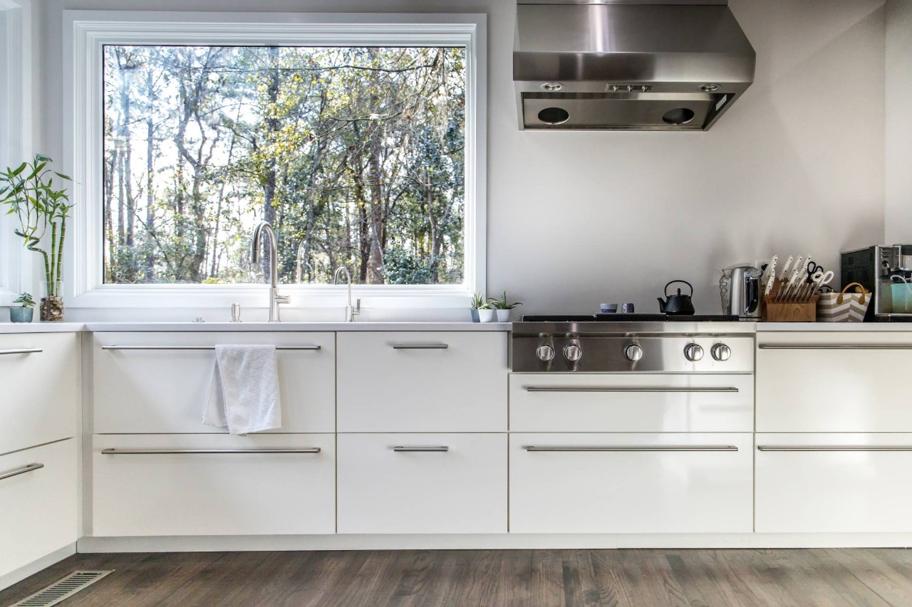 A modern kitchen with a window above the sink at Benchmark Shutters & Shades near Apex, NC